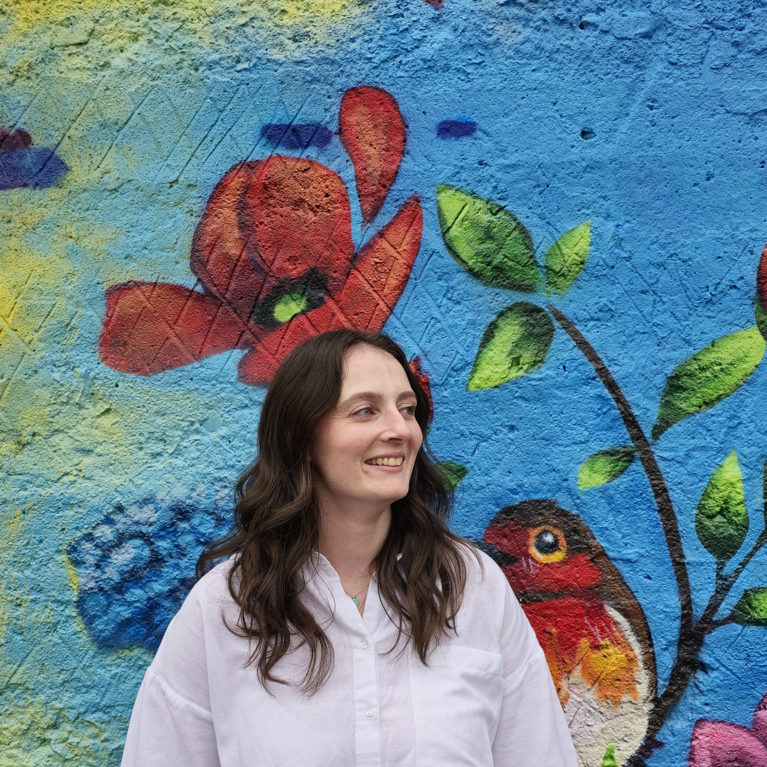 Brooke Quick headshot of Brooke Quick with floral art background